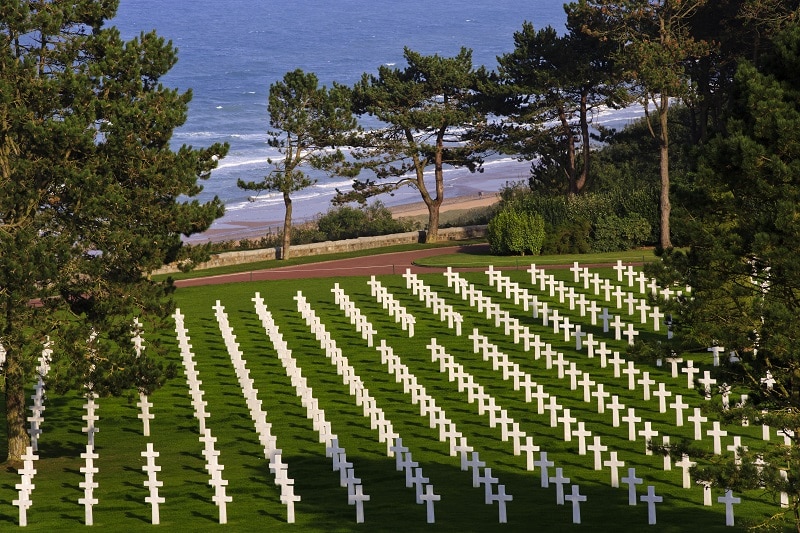 Graves of the fallen are seen with Omaha Beach in the background at the Normandy American Cemetery and Memorial, on September 27, 2013, at Colleville-sur-Mer, France