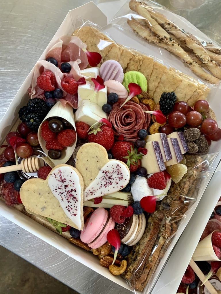 Bramble & Brie Charcuterie Co.'s American Brunch Box including house-made pastries and peach lavender jam along with local honey and other goodies