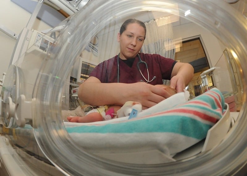 Abortion Navy Medical Officer examines baby during Graduate Program Training