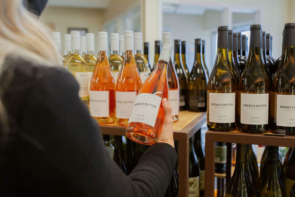Bread and Butter A shopper looking at the different possibilities of wine at Bread And Butter Market in Colorado Springs.