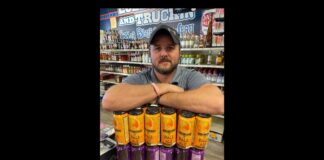 Owner Brent Baldwin of Veterans Wine & Liquor in Colorado Springs holding some product from local brewer Bell Brothers Brewing.