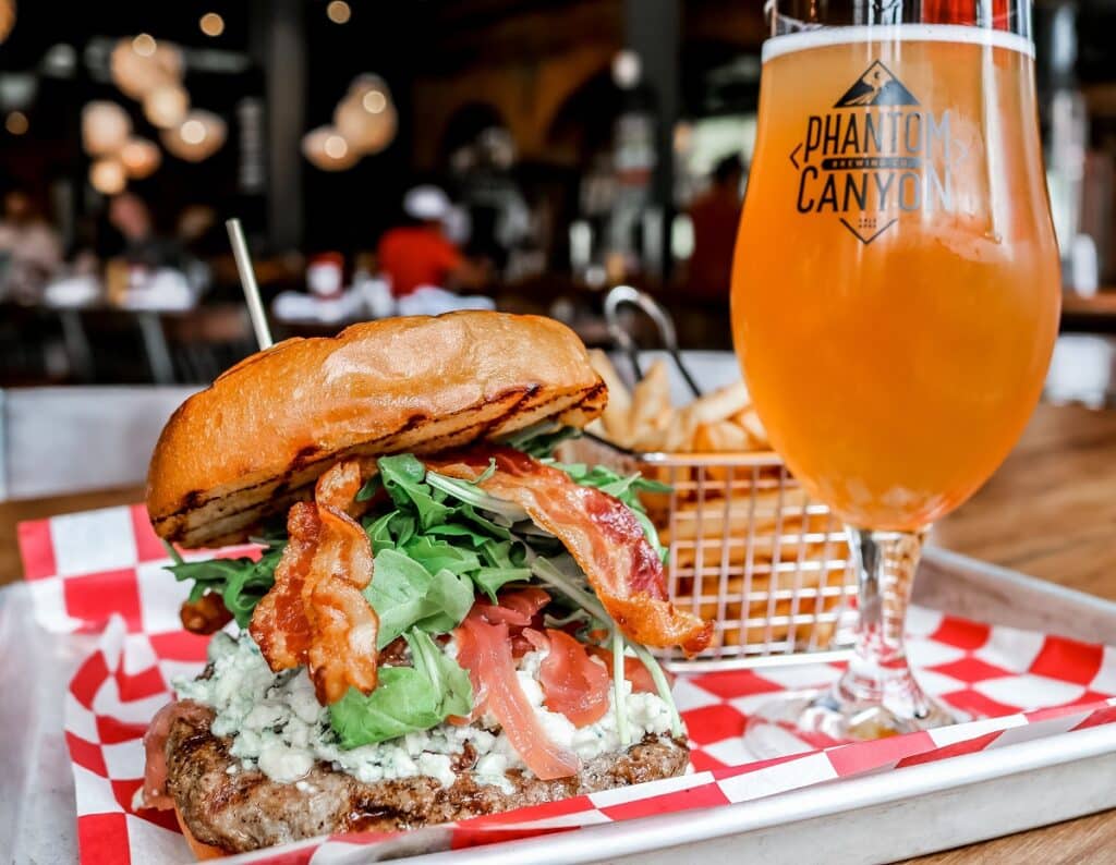 Phantom Canyon Brewing Company The Phantom Burger (all natural Colorado beef, bacon, blue cheese crumbles, red onion jam) with a Phantom brew at Phantom Canyon Brewing Company in Colorado Springs.