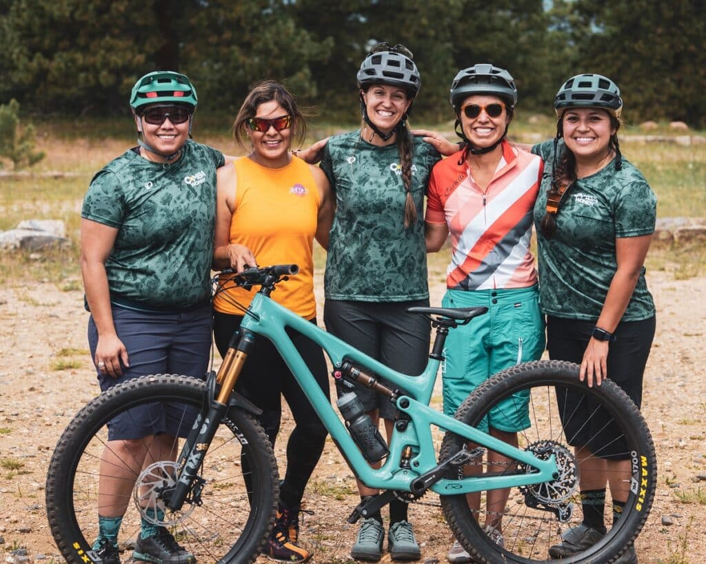 Mountain Biking Certified Coach Natalia Pulido with a group of mountain bike riders.