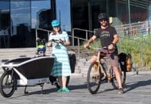Cully Radvillas, Executive Director of the Organization Of Westside Neighbors, along with his wife Hailey and son Quinn in front of the Olympic Museum.