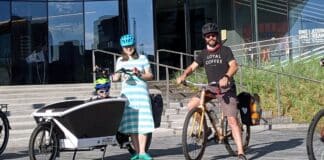 Cully Radvillas, Executive Director of the Organization Of Westside Neighbors, along with his wife Hailey and son Quinn in front of the Olympic Museum.